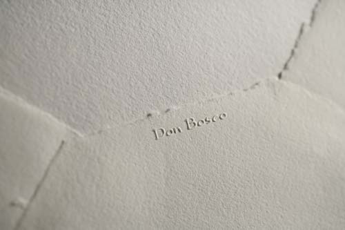 Authenticity embossed mark with our brand, under the flap 