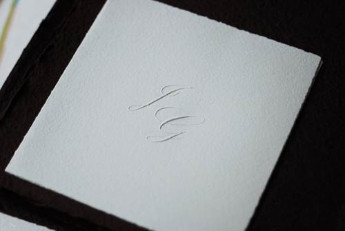 Double wedding invitation with embossed initials