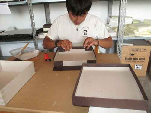 The boxes are handmade and wrapped in brown handmade paper